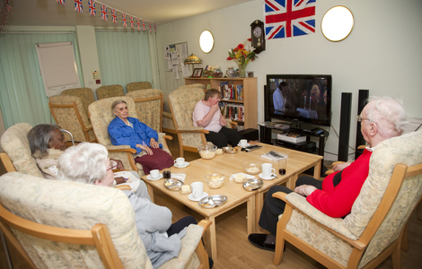 Residents at Miranda House attending their regular film club in the communal lounge at Miranda House 21 Penzance Place London W11 4PD